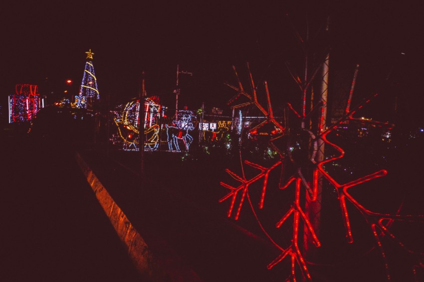 a night scene of a fairground with a lot of lights