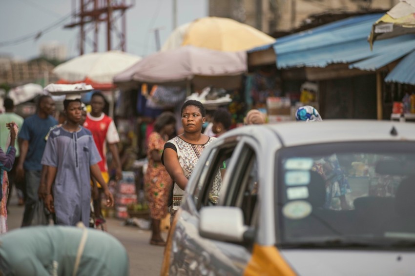 a group of people walking down a busy street