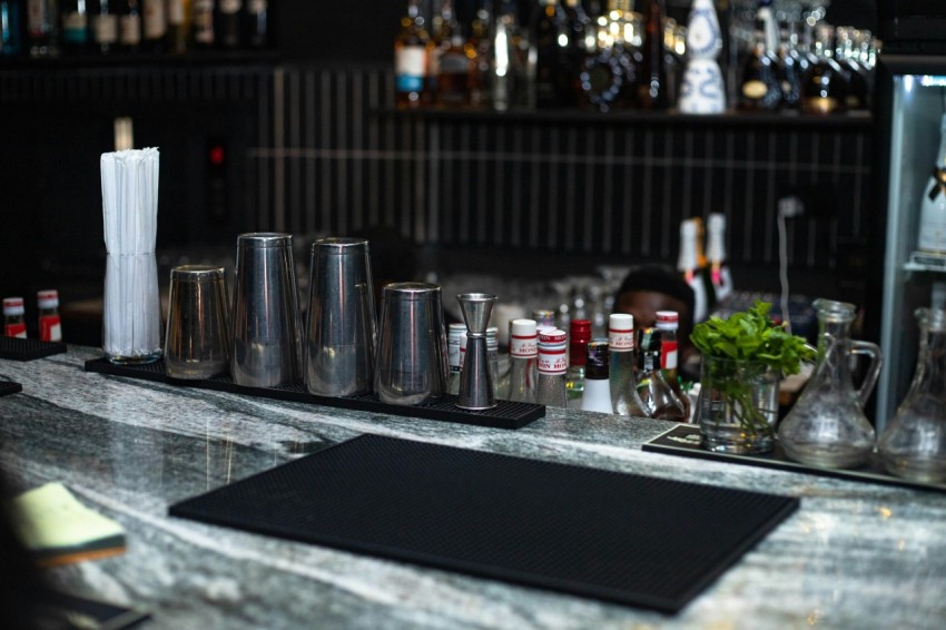 a counter with bottles and glasses on it