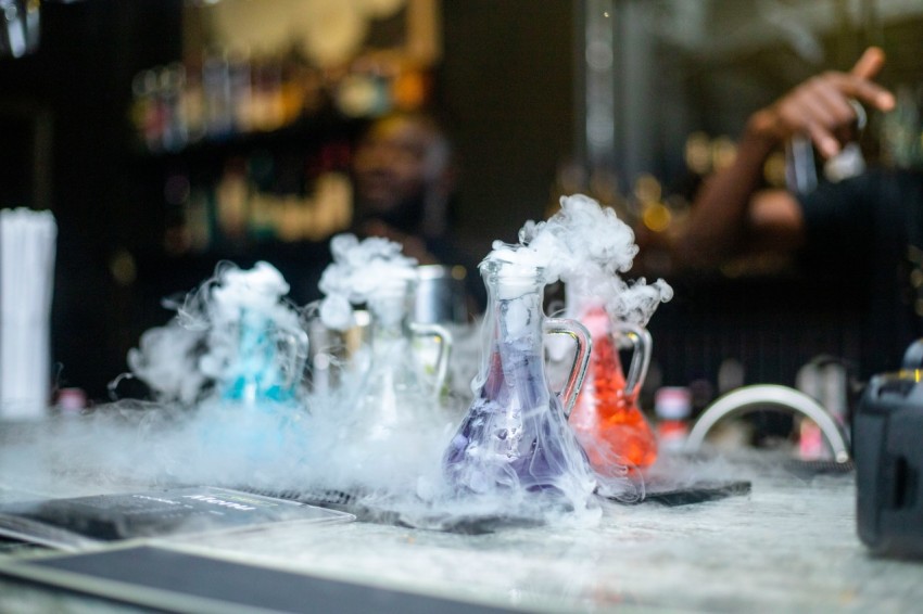 a group of bottles with smoke coming out of them