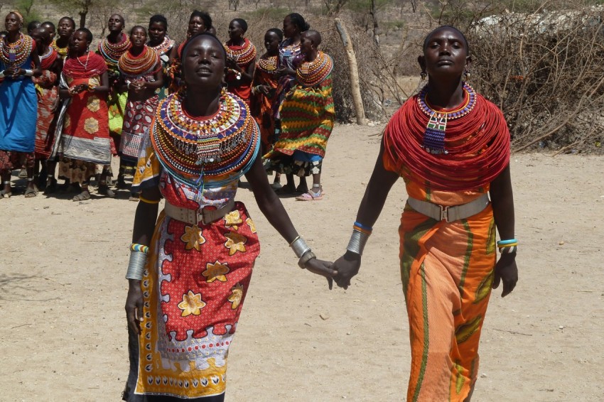 two women holding hands each other