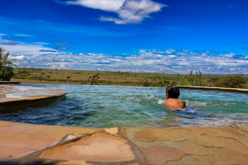 a man swimming in a large pool of water wAUUp