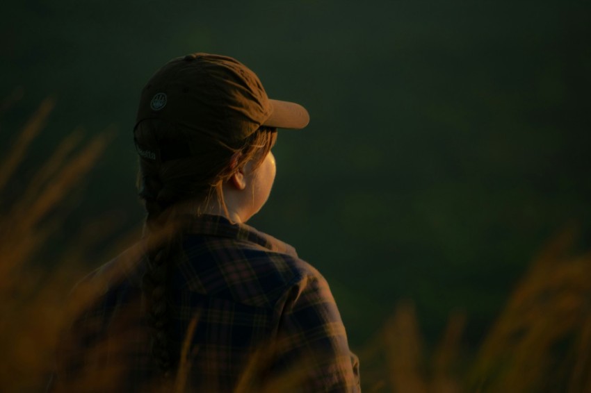 a woman standing in a field of tall grass