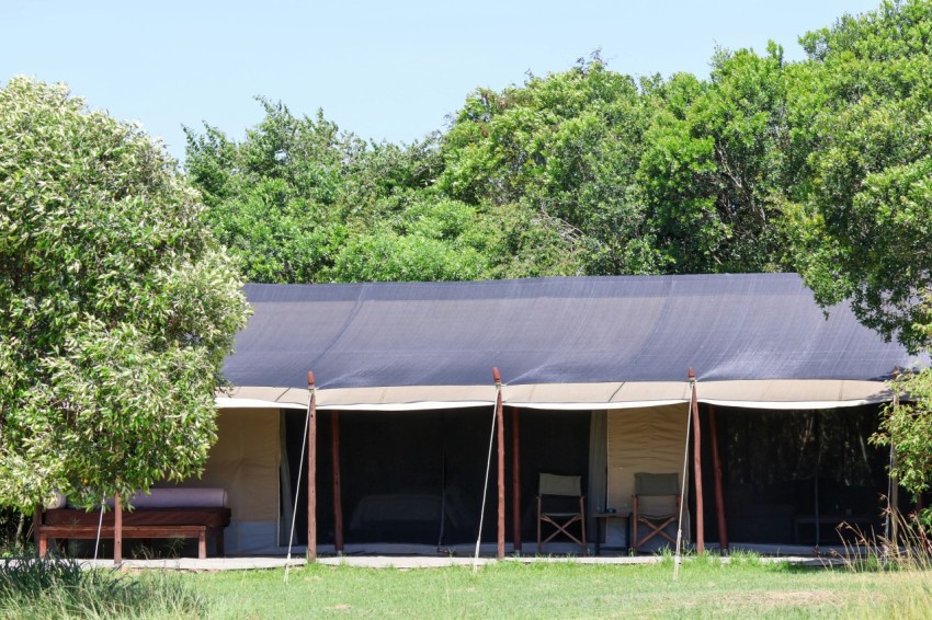 a tent set up in the middle of a field