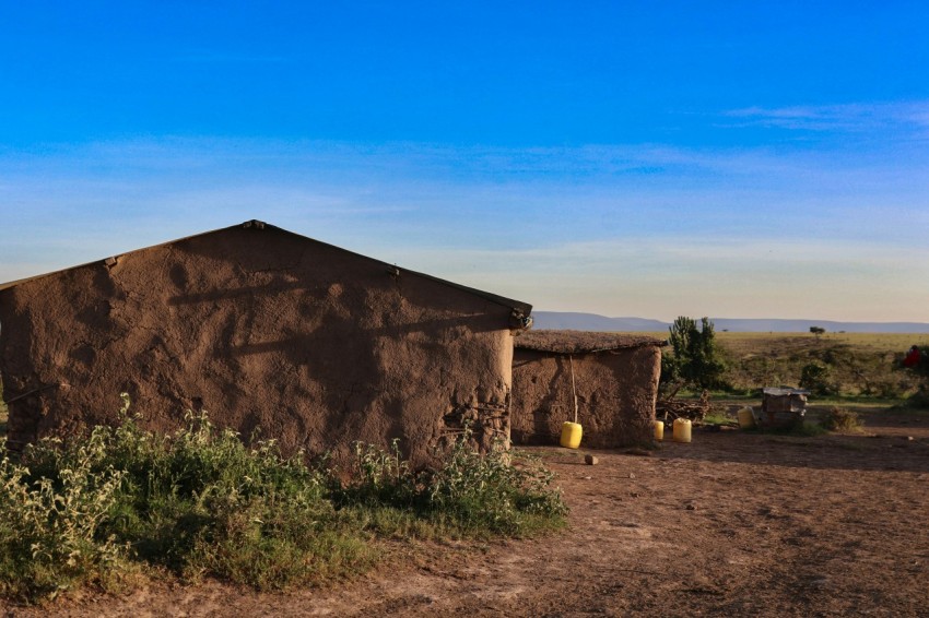 a small adobe building in the middle of a desert