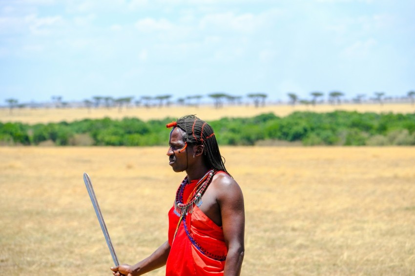 woman in red halter dress holding stick