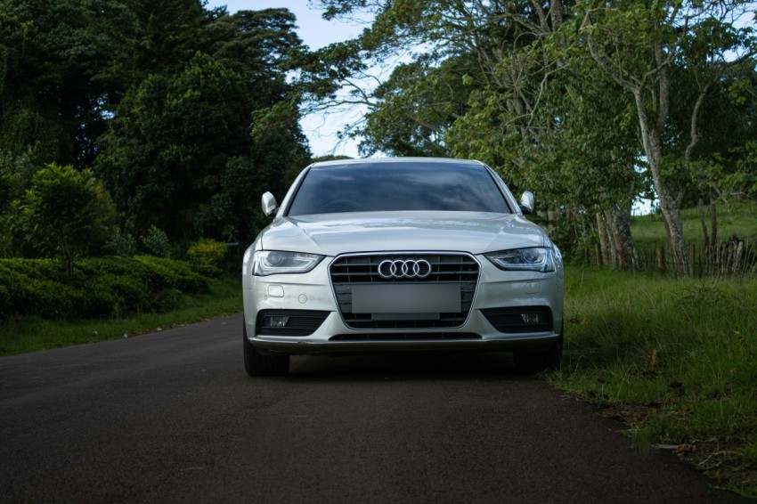 a silver car parked on the side of a road