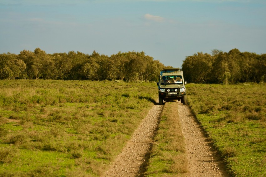 a truck driving down a dirt road