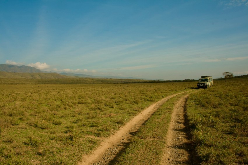 a truck driving down a dirt road