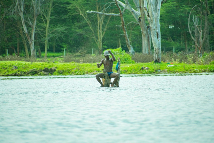 a man riding on the back of a wooden boat