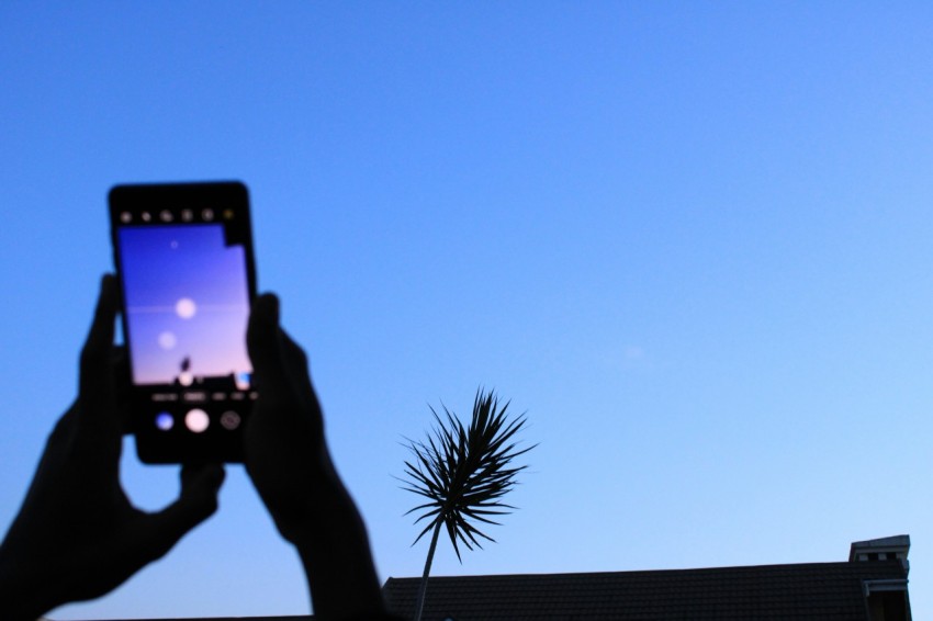 a person taking a picture with a cell phone