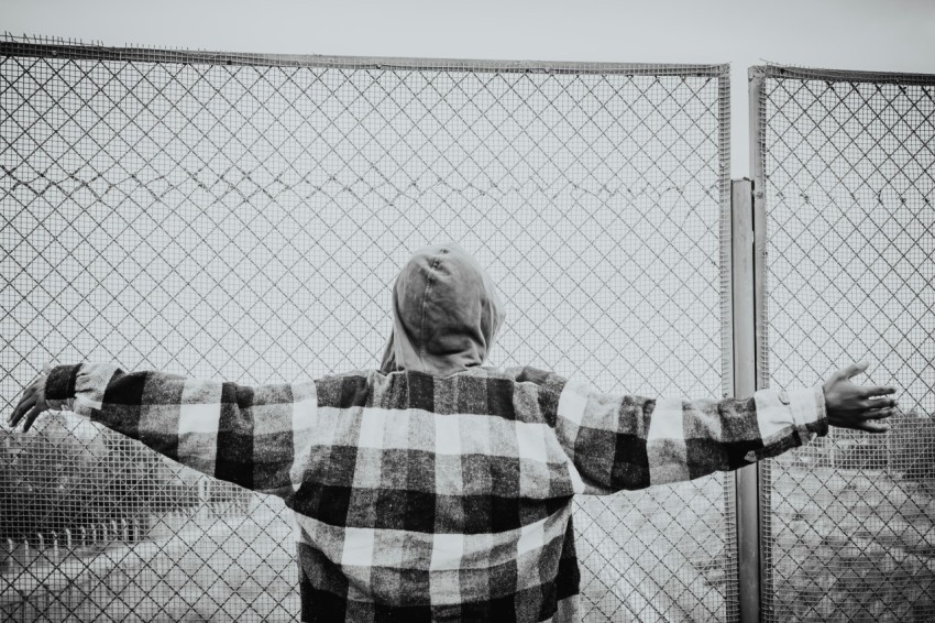 a person standing in front of a fence