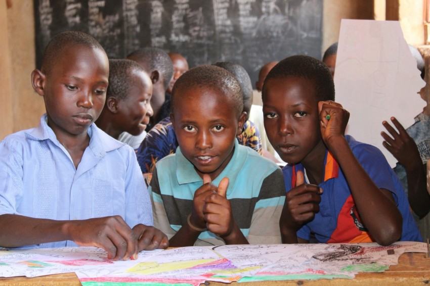 a group of young children sitting at a table