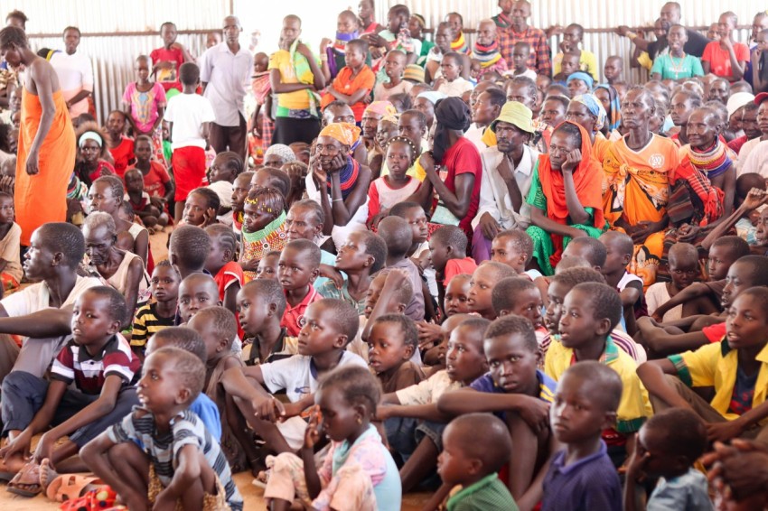 a large group of people sitting on the ground