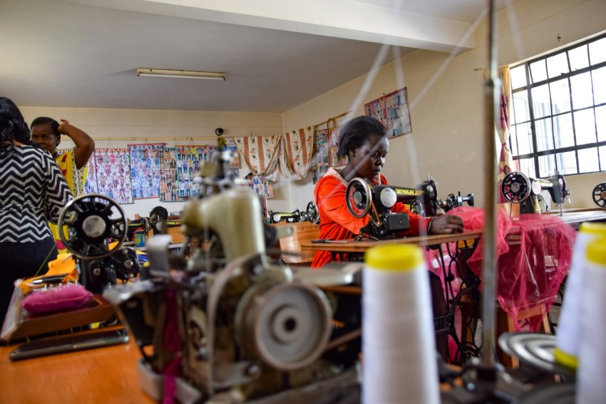 a group of women working on sewing machines aH1uiH