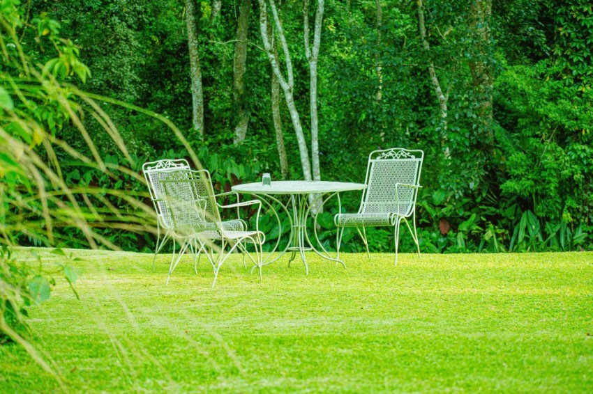 a couple of chairs and a table in a field AXGXb