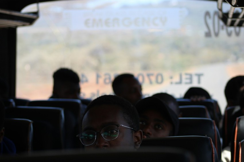 a group of people sitting on a bus