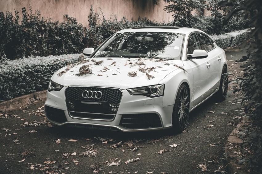 a white car parked on the side of a road