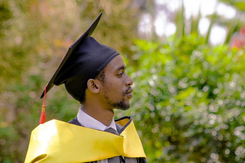 a man in a graduation gown and cap