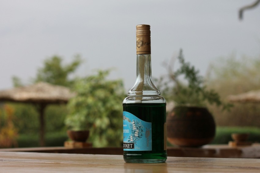 a bottle of olive oil sitting on a table