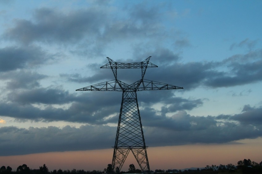 a large power line with a sky background cFngNF