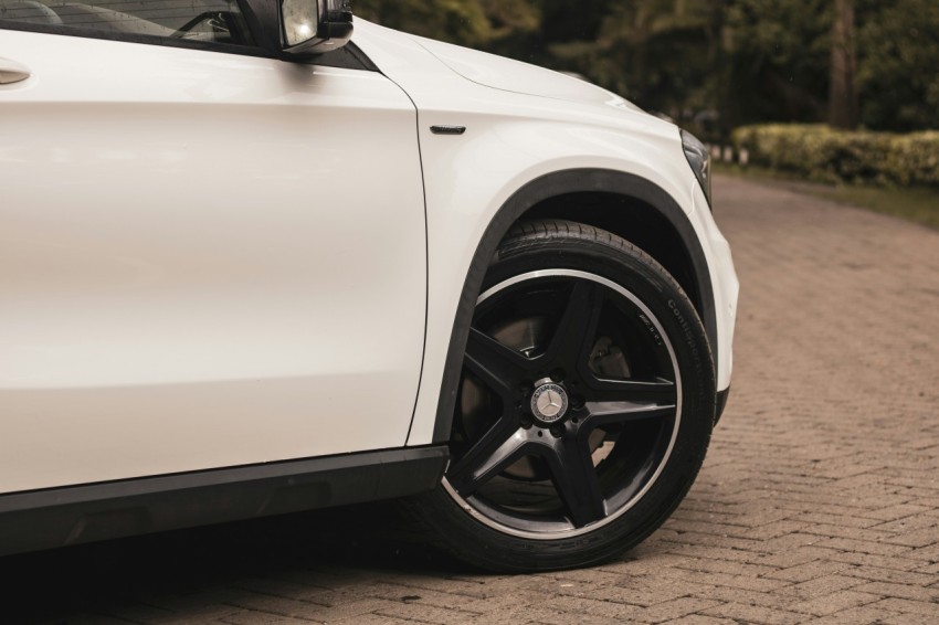 a white car parked on a brick road