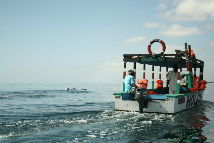 a man sitting on a boat in the ocean