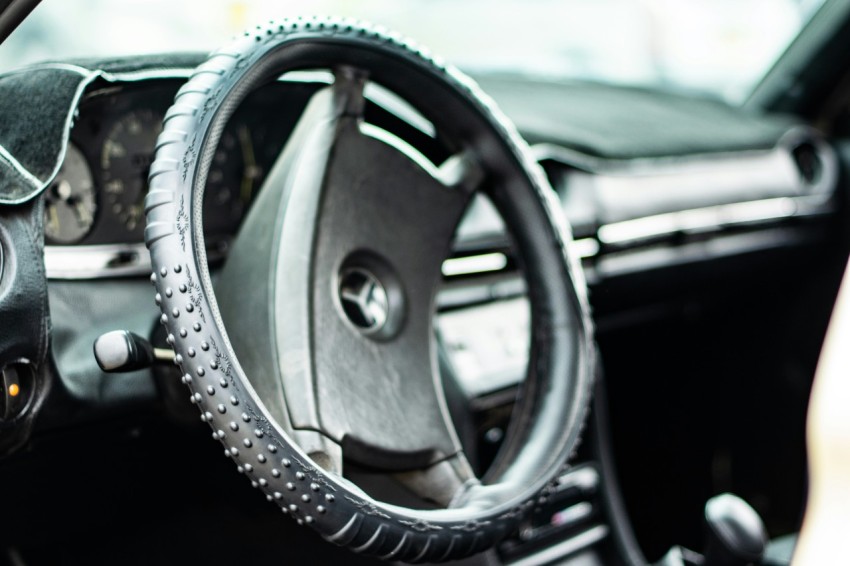 black steering wheel in close up photography