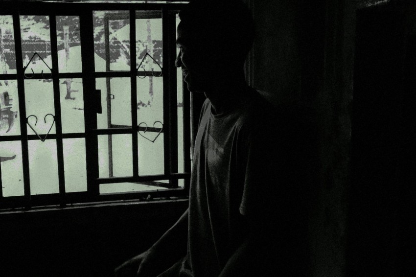 silhouette of person standing near window