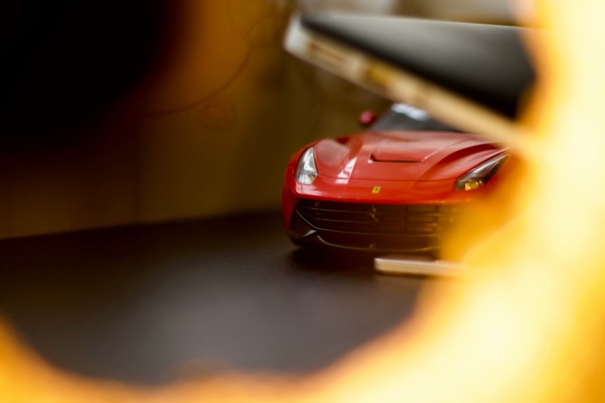 red ferrari car on black road