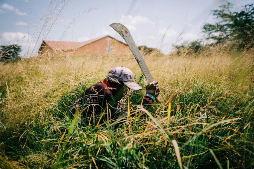 man cleaning field at daytime