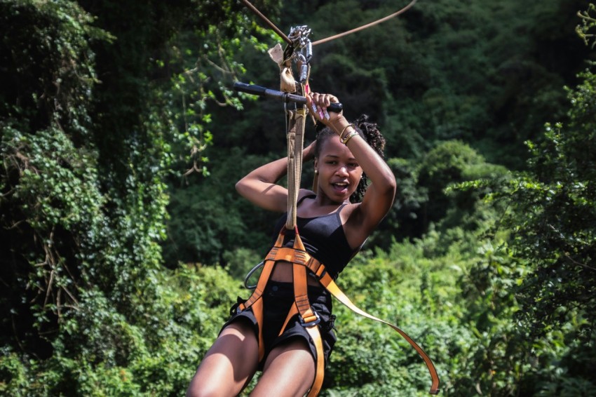 a woman on a zip line in the jungle akR