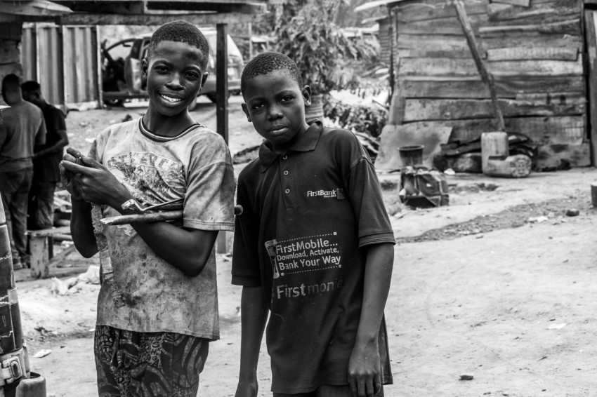 a couple of young boys standing next to each other