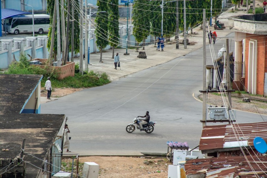 a person riding a motorcycle down a street