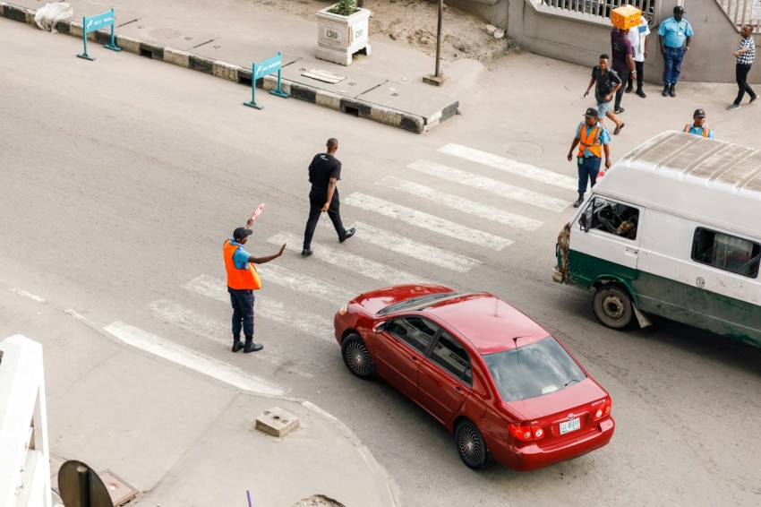 a group of people standing on the side of a road