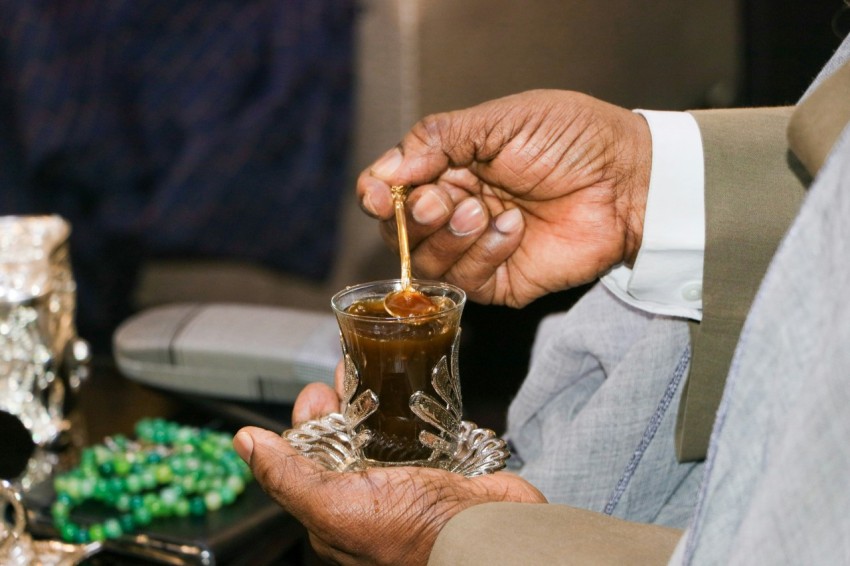 a person pouring a drink into a glass