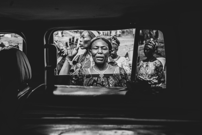 a black and white photo of a woman on a bus