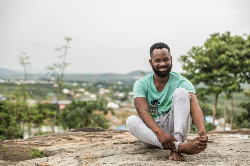 man sitting on rock