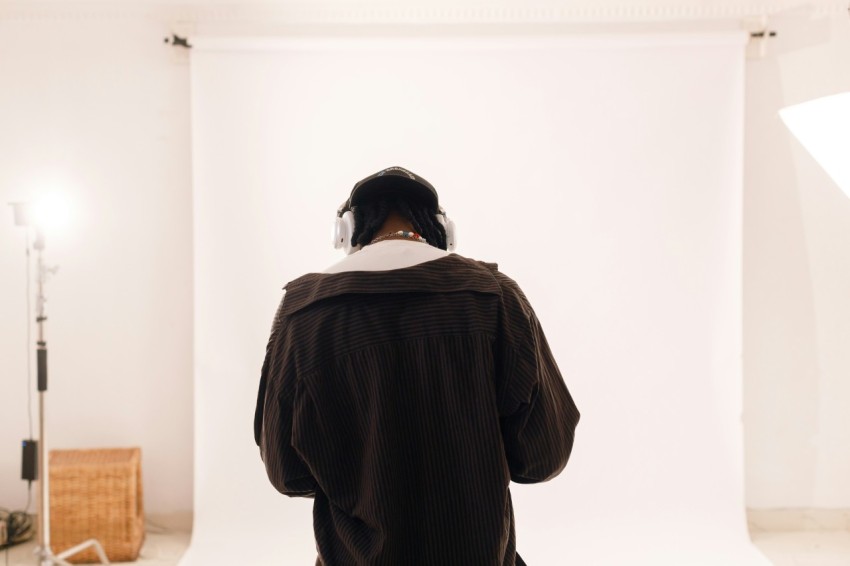 a person standing in front of a white wall