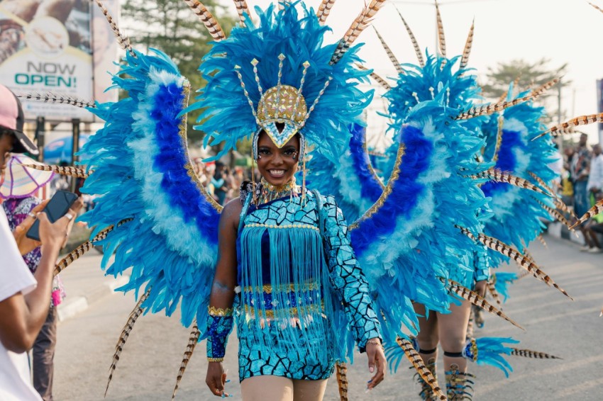 a woman in a blue costume walking down a street