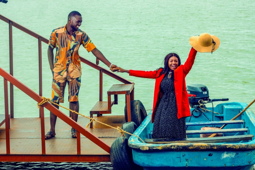 a man and a woman standing on a boat