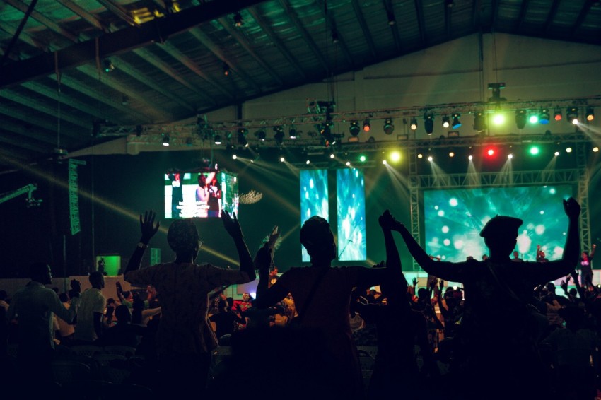 people standing on stage during night time