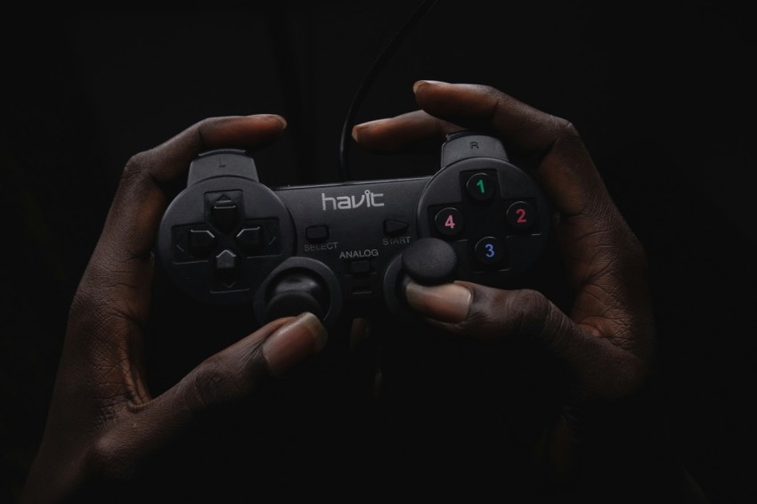 person holding black havit game controller