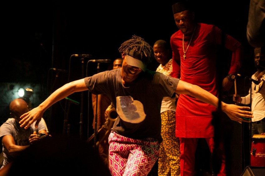 man in red crew neck t shirt holding microphone