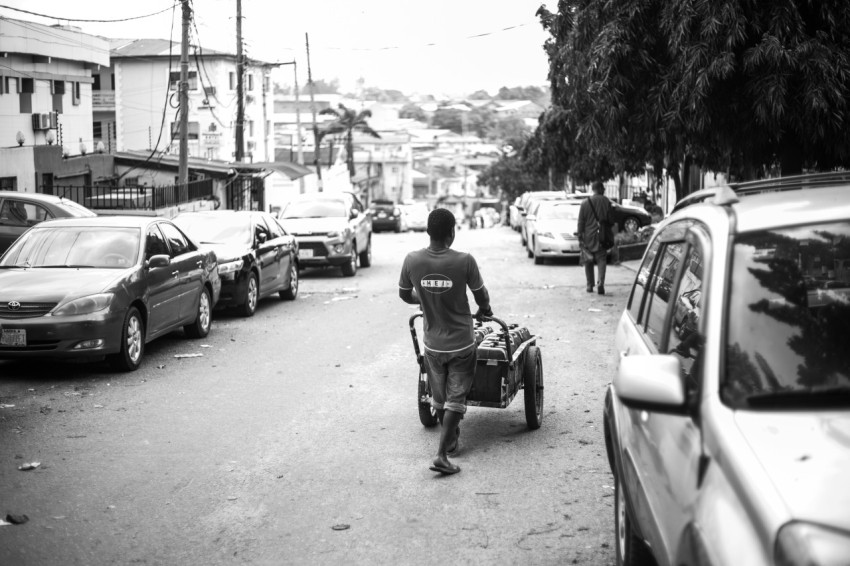 a man pushing a cart with a person on it