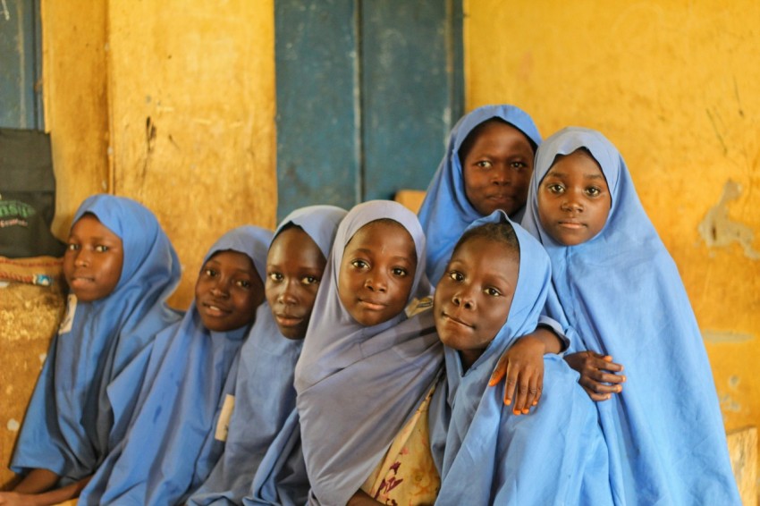 a group of women in blue dresses