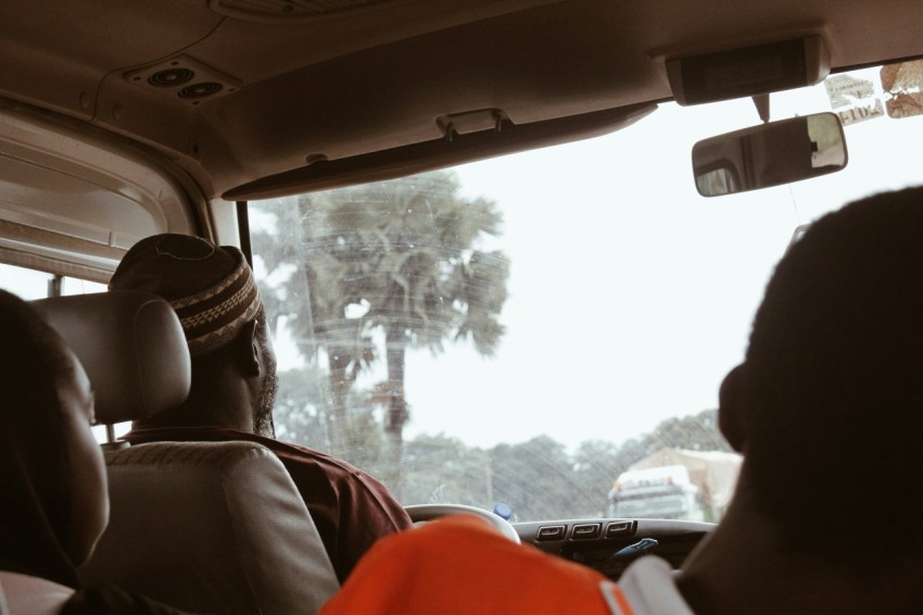 a group of people sitting in the back of a car