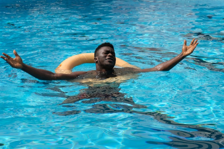 man in swimming pool during daytime