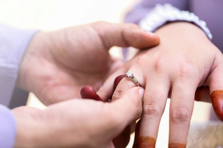 a close up of two people holding hands