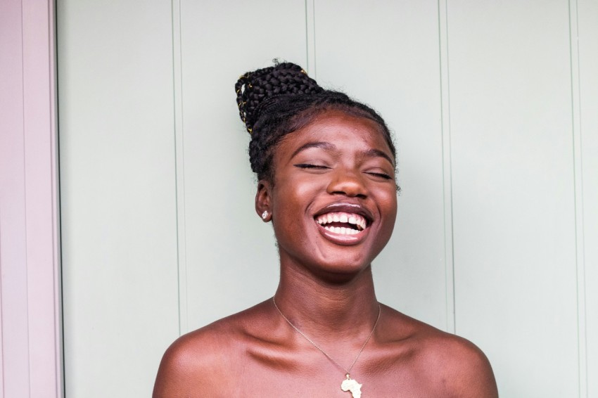 woman wearing gold colored necklace